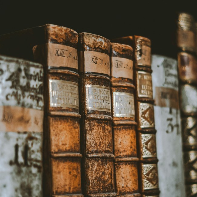Old books on a shelf with a brown background
